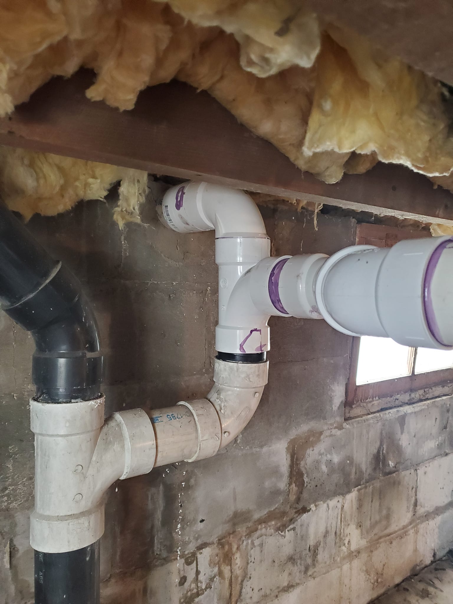 New plumbing line run through ceiling insulation